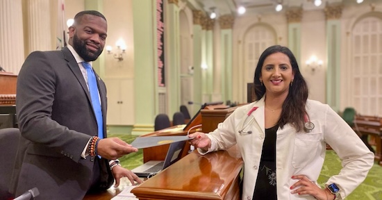 Dr. Bains hands the Grow Our Own Bill to the Clerk of the Assembly